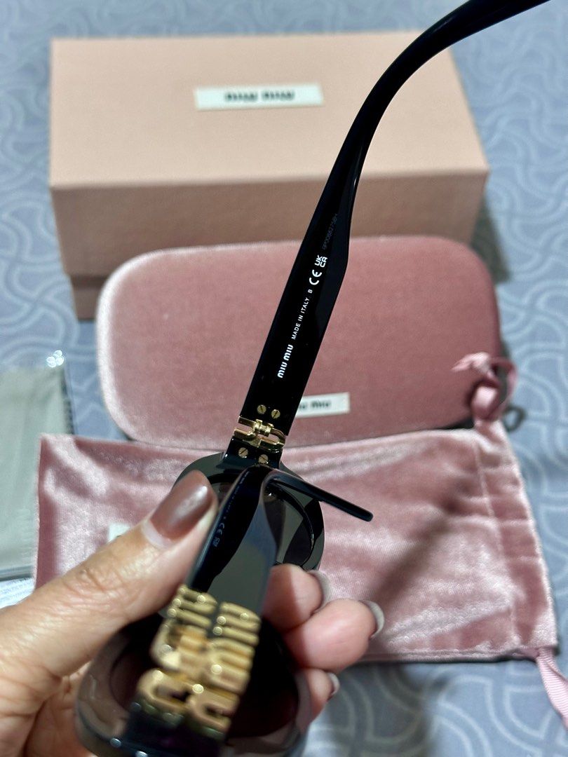 Miu Miu Oval Sunglasses